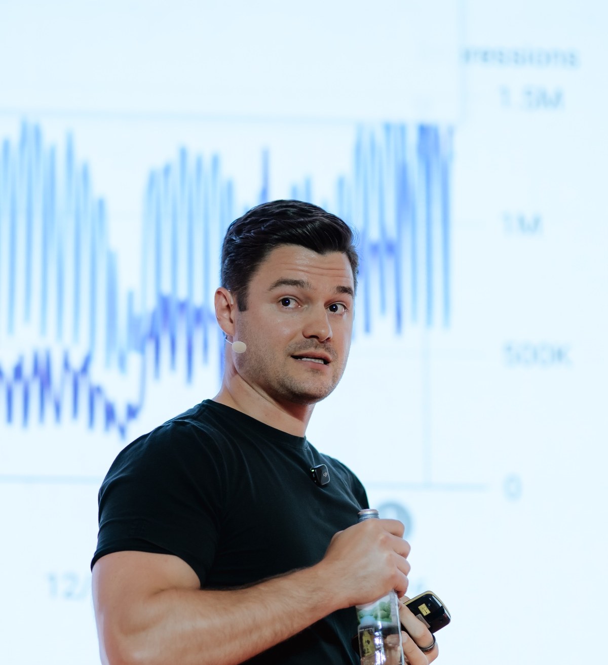 Nathan Latka presenting SaaS growth metrics on stage